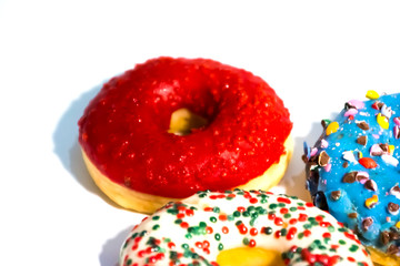 Sweet tasty donuts with colorful sprinkles isolated on white background