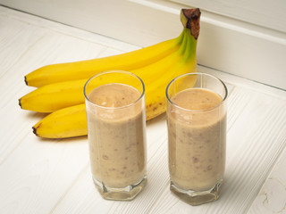 Two glasses with banana smoothies on the table
