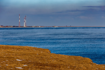 Fototapeta na wymiar Shore of Baikal lake with antenna towers in winter
