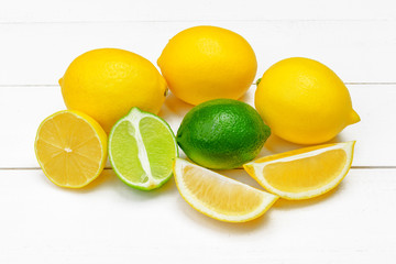 lemons and limes on a wooden background.