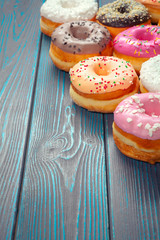 Glazed donuts on wooden background