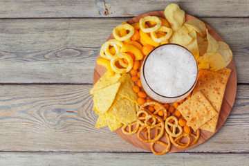 wide selection of snacks for beer on wooden background