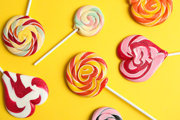 Flat lay composition with different candies on color background, closeup