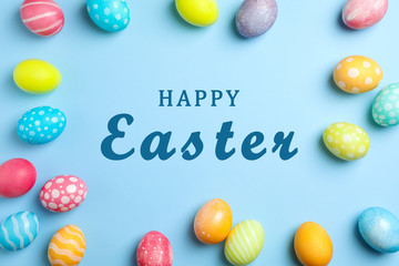 Flat lay composition with Easter eggs on color background, space for text. Top view