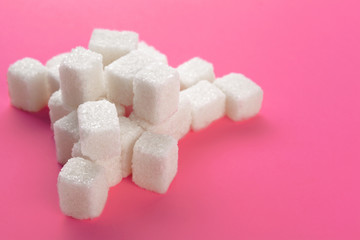Cubes of sugar on a pink background. Empty space for copying text