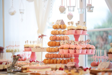 Delicious candy bar with macaroons, cake pops and cupcakes