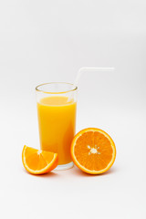 glass of orange juice and sliced orange on a white background