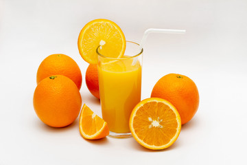 glass of orange juice and oranges on a white background