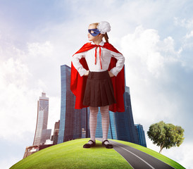 Girl power concept with cute kid guardian against cityscape background