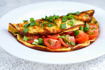 Omelette with cherry tomatoes, toasts with cream cheese and greenery
