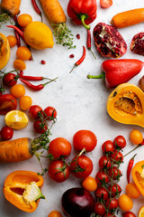 Flatlay with colorful vegetables and copy space arranged on white background. Tomatoes, squash and peppers. Frame shape with space in centre. Vegan nutrition concept