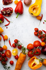 Flatlay with colorful vegetables and copy space arranged on white background. Tomatoes, squash and peppers. Frame shape with space in centre. Vegan nutrition concept