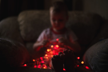 A child plays with a Christmas garland