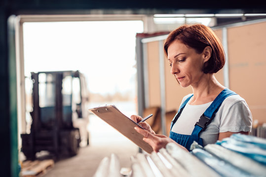 Stock Clerk Checking Warehouse Inventory