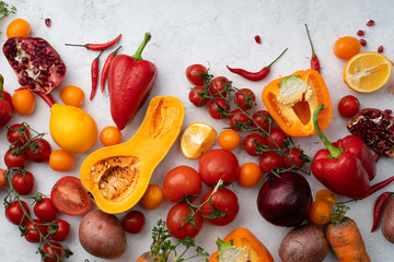 Flatlay with colorful vegetables and copy space arranged on white background. View from above. Vegan nutrition concept
