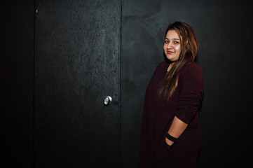 Asian girl against dark black background.