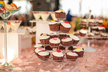 Delicious candy bar with cupcakes and other sweets
