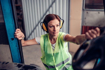 Woman forklift operator entering vehicle © kerkezz