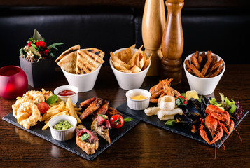 fried seafood squids, shrimps, mussels sauce on wooden