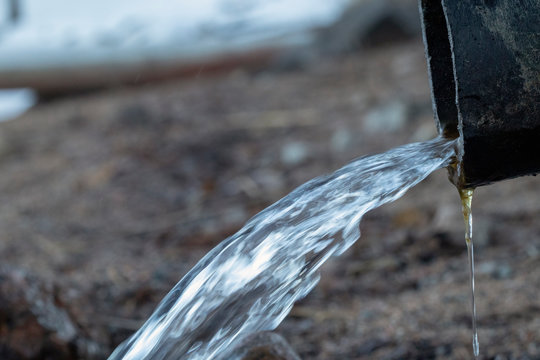 Water Running Out Of Industrial Pipe Into A Lake, Finland