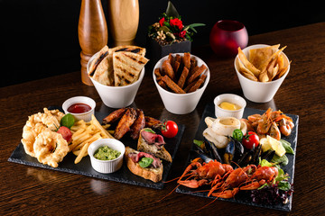 Set of seafood: red and black caviar, limb of hairy crab, limb of snow crab, far eastern kamchatka crab