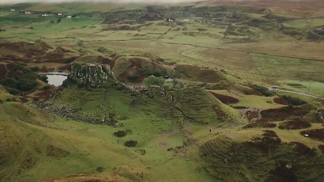 An arc shot of the unique landscape of Fairy Glen and Castle Ewen on a cloudy evening day, in Uig, Scottish Highlands