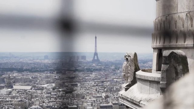 SLOW MOTION: Eiffel Tower of Paris tries to hide behind unsharp fence