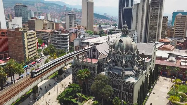 Incredible aerial shot of metro train and Botero Plaza in Medellin city center