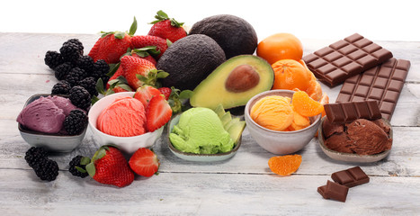 Set of ice cream scoops of different colors and flavours with berries, chocolate and fruits.