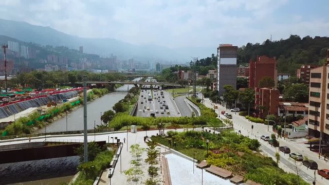 Stunning slow aerial shot of busy roads and streets of Medellin in summer