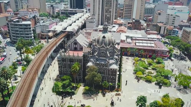 Orbiting drone footage showing beautiful crowded square of Botero in Colombia