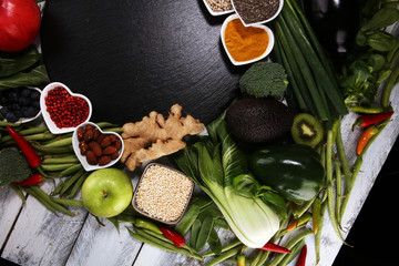 Obraz na płótnie Canvas Healthy food clean eating selection. fruit, vegetable, seeds, superfood, cereals, leaf vegetable on rustic background
