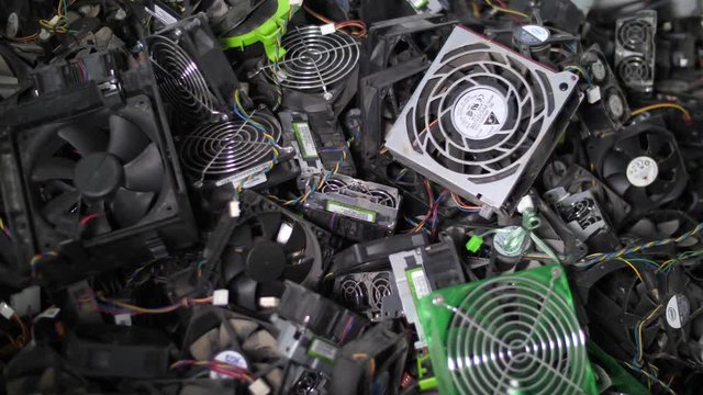 Recycling concept. Sorting computer components. Close up of stack of ventilators