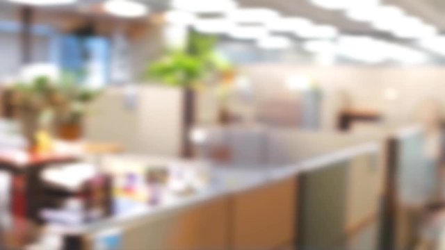 Blurred time lapse of people moving fast in corporation office