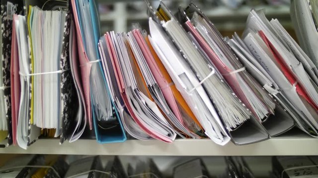 Stack of files lying on the shelf in archive. Dolly close up