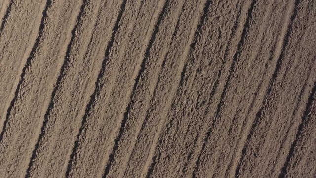 Cultivated earth with tractor plough 4K aerial video