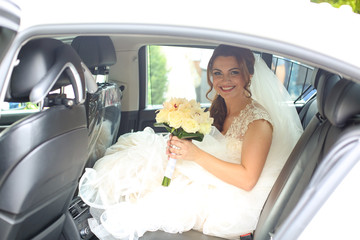 Beautiful bride posing in car