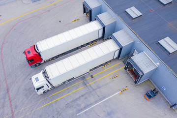Aerial Top View of White Semi Truck with Cargo Trailer Parking with Other Vehicles on Special...