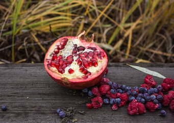Fresh organic jucy Pomergranate. style rustik . selective focus.