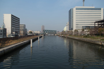 Cityscape with river, bridges and buildings in Osaka in spring clear day