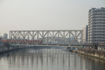 Cityscape with river, bridges and buildings in Osaka in spring clear day