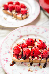 Homemade Toasts with Goat Cheese, Raspberries, Balsamic Cream and Pine Nuts