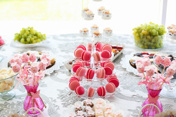 Delicious candy bar with cupcakes, cake pops and other sweets