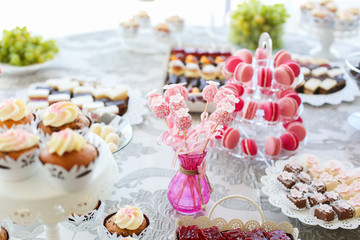 Delicious candy bar with cupcakes, cake pops and other sweets