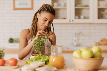 Healthy woman sitting at the table with fruits and vegetables