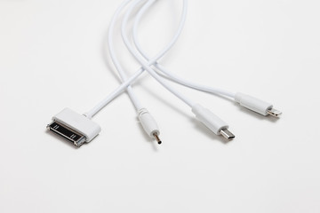 Fototapeta premium white universal charging cable, adapter with micro USB, usb connectors for different models of phones and devices on a white background