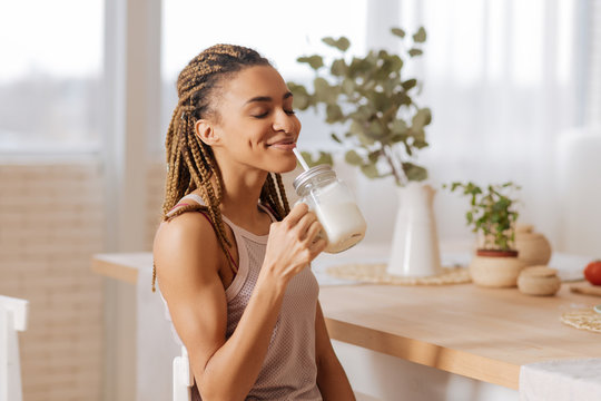 Woman after finishing workout drinking protein shake