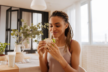 Woman feeling excited before eating healthy sandwich after workout