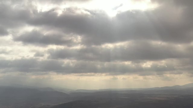 Dramatic sky with rays of sun through the clouds 4K drone video