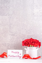 May mothers day handmade giftbox wishes design photography - Beautiful blooming carnations in vase isolated on gray, wooden background table, close up, copy space, mock up